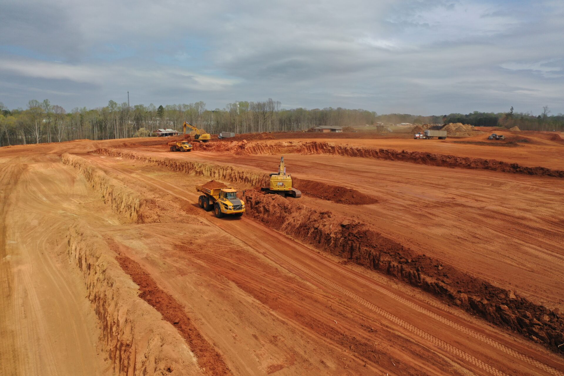 CAT machines grading the china grove job site to make the ground level