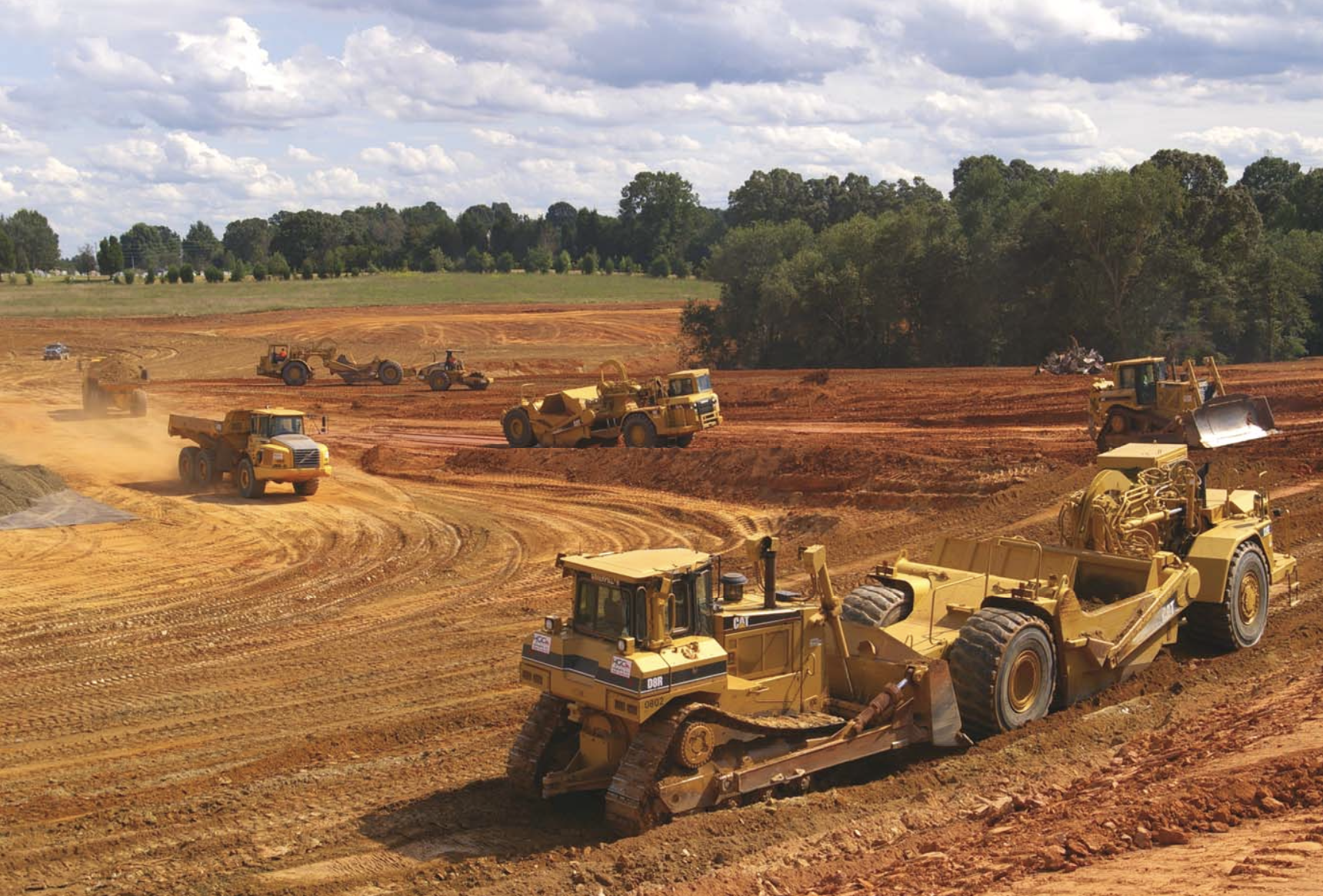 a yellow piece of cat equipment on the project dolphin job site