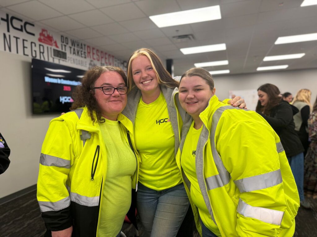 women in construction hugging each other