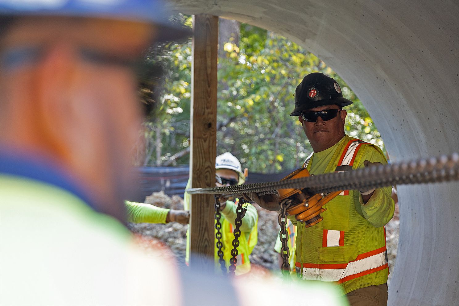HGC Utilities Crew Measuring Large Pipe