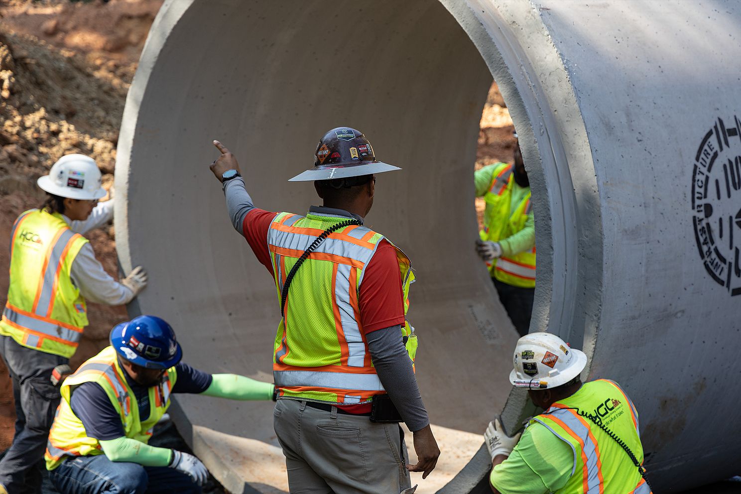 HGC Utilities Crew Moving Large Pipe showing how to implement utility coordination